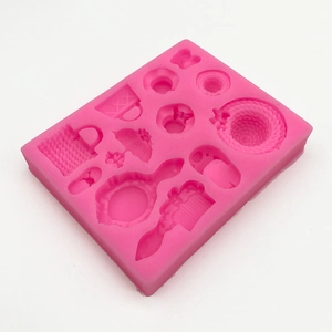 Pink silicone mold featuring shapes of ladies bags, hats, mirrors, and combs for fondant