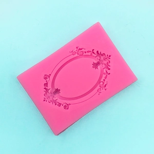 Detailed macro view of pink silicone mold with baroque frame and floral embossed patterns
