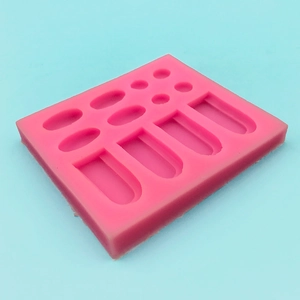 Pink silicone mold with cylinder and oval shapes for baking and resin craft projects