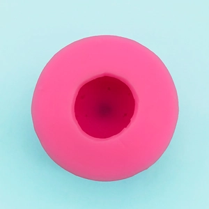 Macro detail of pink round silicone mold for 3D Christmas egg crafts and soap making
