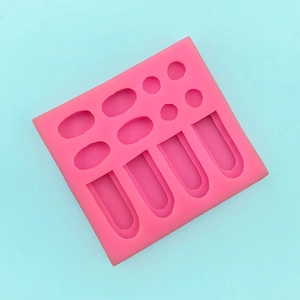 Detailed top view of 12-cavity pink silicone mold for rabbit ear fondant shapes