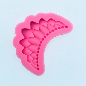 Detail view of pink silicone crown mold with layered wave texture for cake decorating