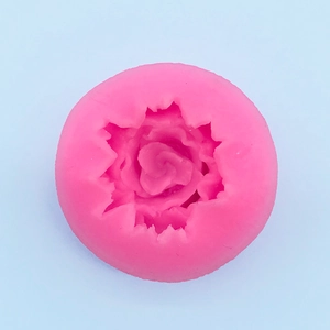 Detailed top view of pink silicone mold featuring a small rose flower relief for DIY baking