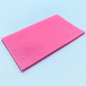 Macro detail of pink silicone mold featuring textured mermaid fish scale patterns