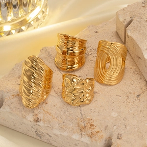 Set of four gold-plated titanium steel rings with irregular hammered and woven textures