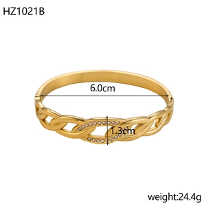 Bracciale rigido a spirale in acciaio dorato con dettagli in pavé di diamanti