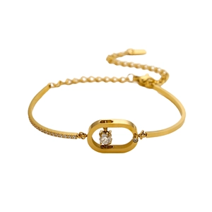 Elegante brazalete dorado con marco ovalado hueco y piedra central de circonita suspendida