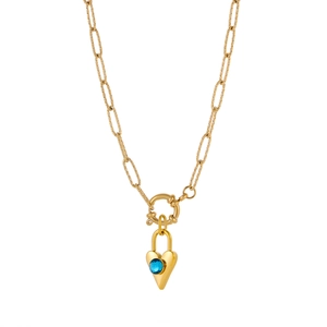 Detail of gold heart lock pendant with a blue gemstone on paperclip toggle necklace