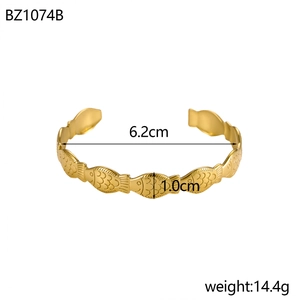 Detail of gold fish-patterned stainless steel open cuff bracelet with glossy finish