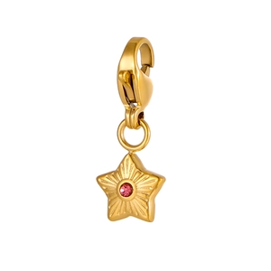 Detailed macro view of a gold star pendant with a pink gemstone and radial texture