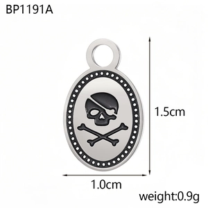 Detailed close-up of a stainless steel pirate skull pendant with engraved crossbones