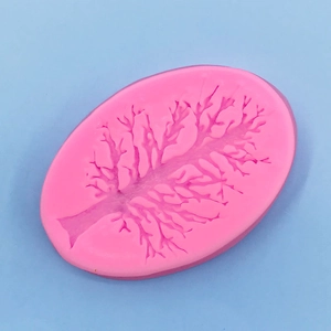Macro detail of pink silicone mold with intricate tree branch textures for cake decorating