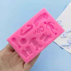 Pink silicone soccer mold with ball, jersey, trophy, and shoe shapes for DIY crafts