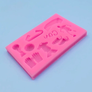 Pink silicone mold with football, trophy, jersey, and goal shapes for DIY cake decorating