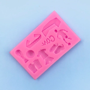 Detailed pink silicone mold featuring soccer balls, cleats, jerseys, and goal shapes