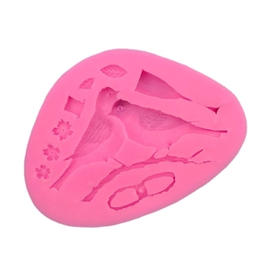 Pink silicone mold featuring bird, flowers and leaves for fondant cake decorating