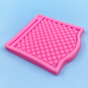 Detailed close-up of pink silicone mat with textured square grid for cake fondant molding
