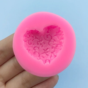 Pink heart-shaped silicone mold with floral vine embossing for baking and chocolate craft