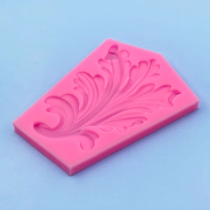 Pink silicone leaf mold for fondant cake decoration and chocolate crafts on blue background