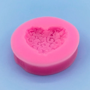 Pink heart silicone mold with floral vine patterns for cake baking and soap making