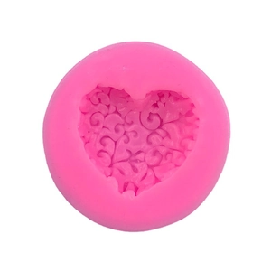 Pink heart-shaped silicone mold with scroll relief pattern for baking and DIY crafts