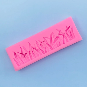 Pink silicone mold featuring detailed grass textures for cake decorating and DIY crafts