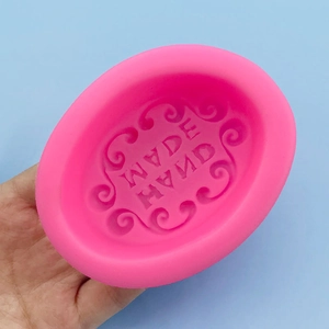 Pink oval silicone mold with handmade lettering and floral pattern for soap making