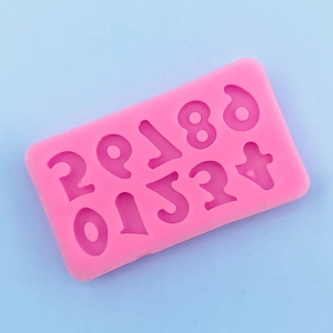 Macro detail of the bright pink 0-9 number silicone mold for DIY baking and crafts