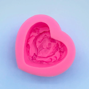 Vue détaillée de dessus du moule en silicone coeur rose avec relief d'ange délicat