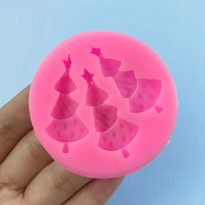 Pink silicone mold with three Christmas tree shapes for baking fondant and DIY crafts