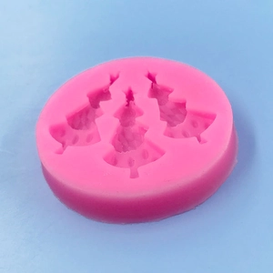Pink silicone mold with three Christmas trees for fondant chocolate cake decoration