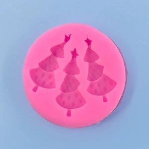 Detailed top view of pink silicone mold with three different Christmas tree designs