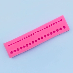 Detailed macro view of pink silicone mold with double pearl beads for fondant DIY cake decor