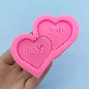 Pink heart-shaped silicone mold with 2PM embossing for baking chocolate and fondant decoration