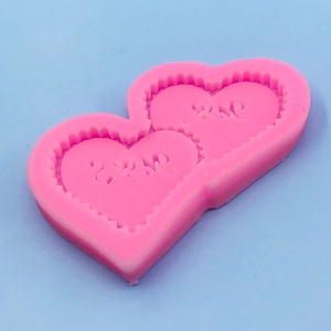 Pink heart-shaped silicone mold with MR and MRS lettering for chocolate and fondant baking