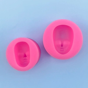 Detail showing two pink silicone face molds for fondant, clay, and soap crafting projects