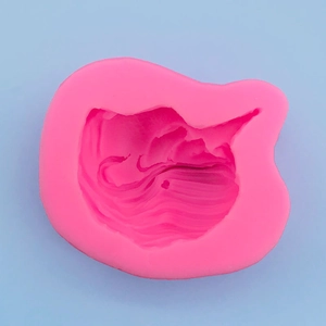 Detailed macro view of pink silicone mold featuring a cute cartoon cat head shape