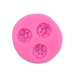 Pink circular silicone mold with three daisy flower patterns for DIY cake decorating
