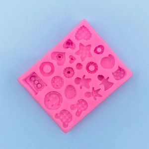 Detailed top view of pink silicone mold with star heart and gingerbread man shapes