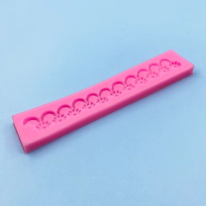 Pink silicone cake lace mold with continuous floral pattern for fondant decoration