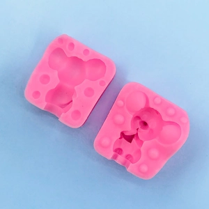 Detail of pink silicone mouse and cheese mold set for cake decorating and chocolate DIY