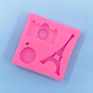 Detail view of pink silicone mold with Eiffel Tower and SLR camera shapes for baking