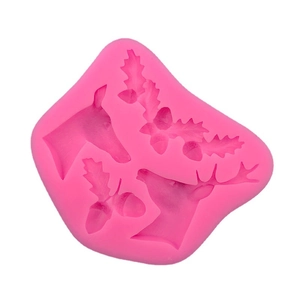 Pink silicone mold with reindeer heads and holly leaves for DIY cake and chocolate crafts