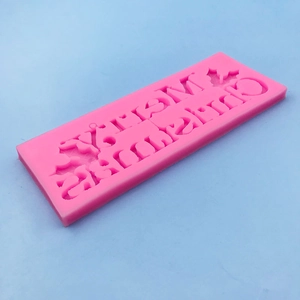 Pink silicone Merry Christmas mold for fondant and chocolate baking with holly leaf detail