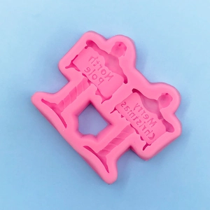 Detail view of pink silicone mold with North Pole and Merry Christmas signage designs