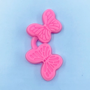 Detail of pink silicone butterfly mold for DIY straw toppers and fondant cake decor