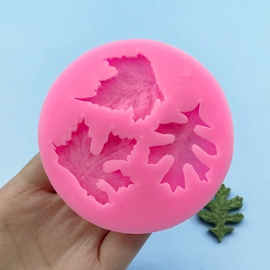 Pink silicone leaf mold for fondant cake decor featuring maple and oak leaf patterns