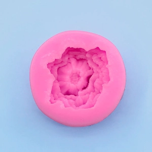 Macro detail of a round pink silicone mold with layered flower petal textures