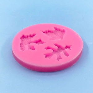 Pink round silicone leaf mold featuring three maple leaf textures for DIY cake decoration