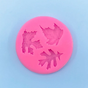 Detailed macro view of pink silicone mold featuring intricate maple and oak leaf patterns